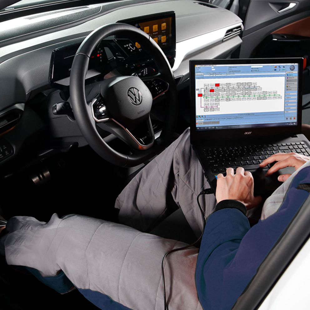Man looks at his tablet in an electric vehicle